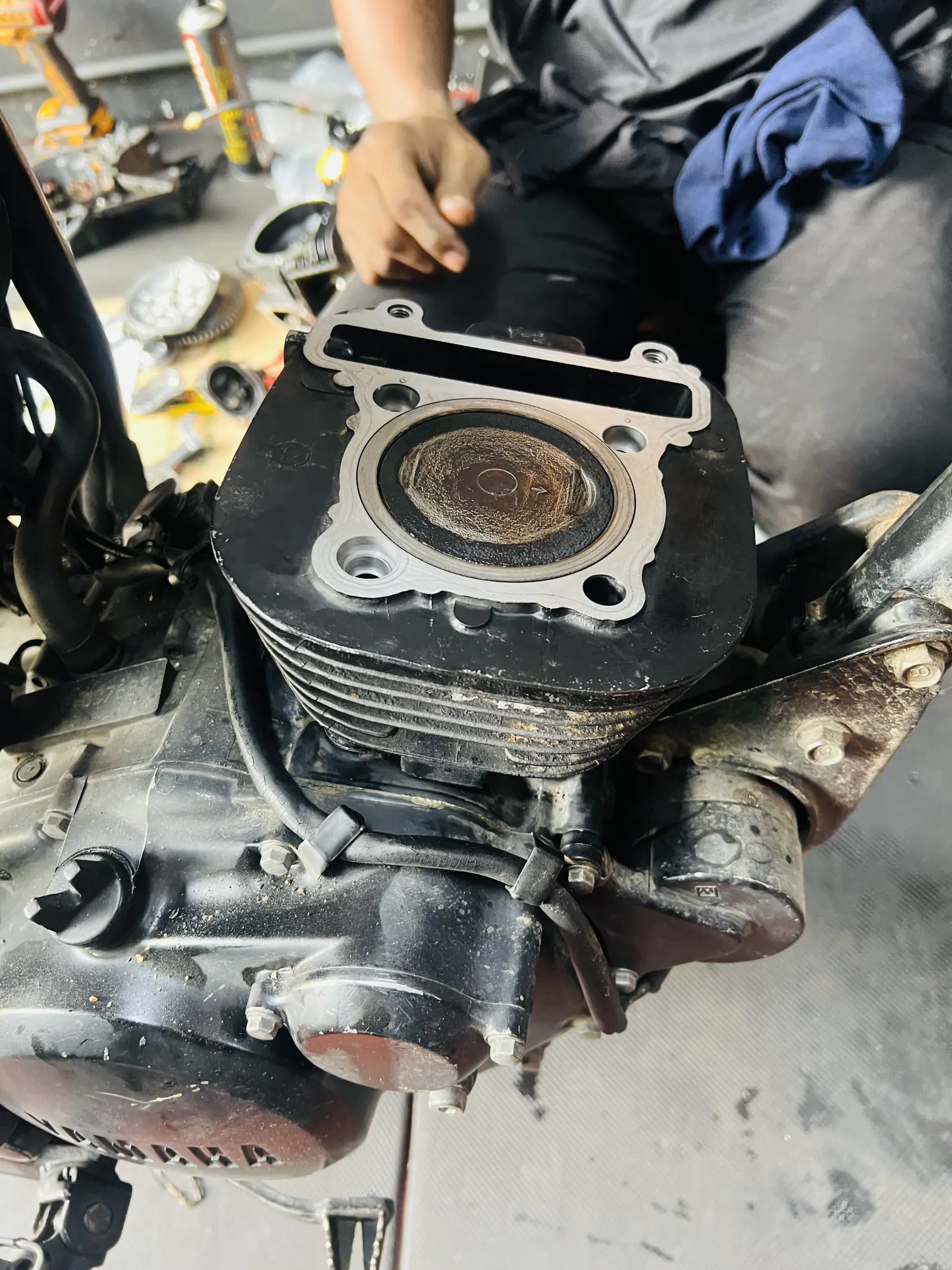 Open motorcycle cylinder showing piston condition during diagnosis