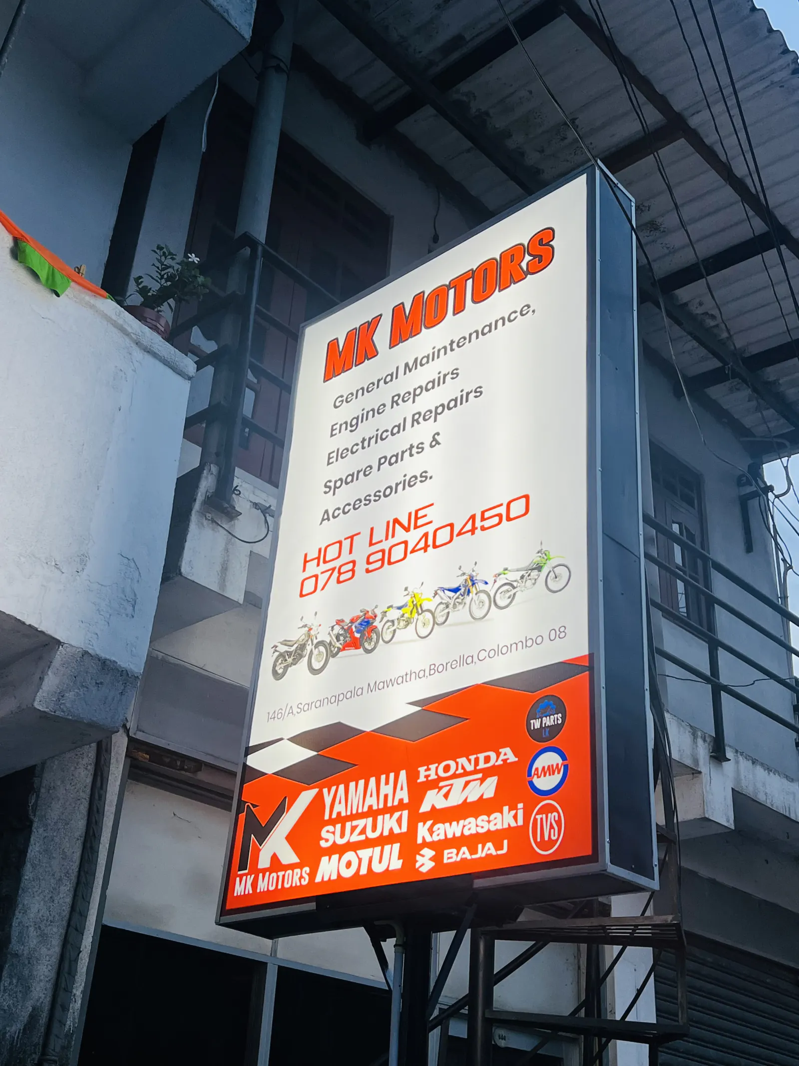 MK Motors illuminated sign outside the Borella workshop